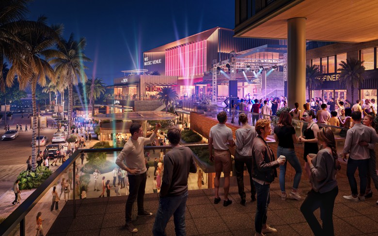 A high-angle rendering from a balcony overlooking a crowded entertainment plaza at night. In the center, a performer is visible on an outdoor stage with professional lighting, situated next to the "WS Music Venue" building.